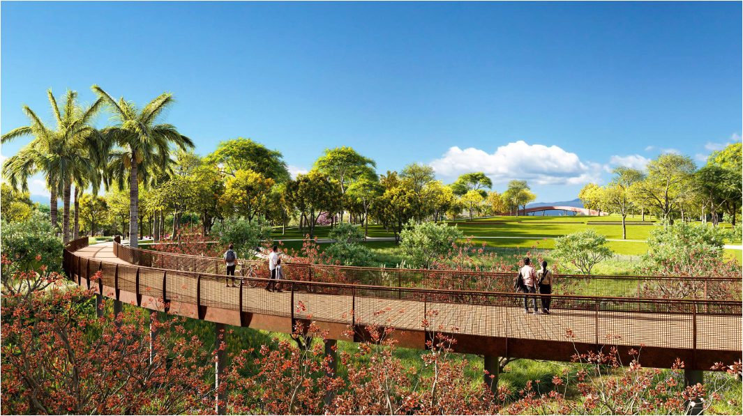 Passarela do Parque Una entre a vegetação, com o gramado do Parque Central ao fundo — imagem ilustrativa